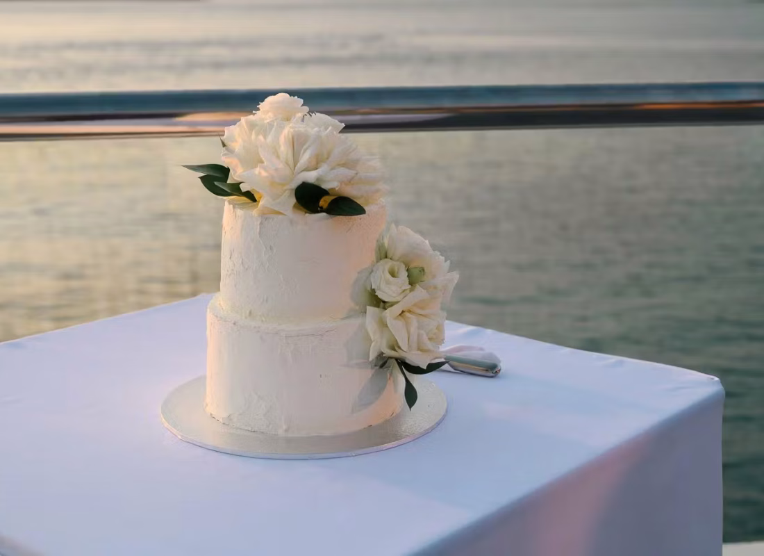 Pasadena couple admiring custom wedding cake delivered and set up at their local reception venue