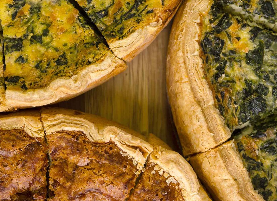 Expert bakers at Roland's Swiss Pastry & Bakery consulting on customized pastry options for a client