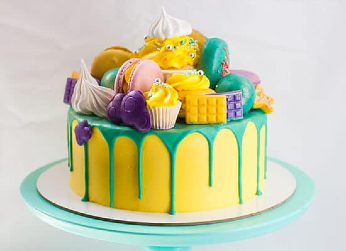 Pastry chef decorating a three-tiered custom cake for a wedding in The Woodlands, TX