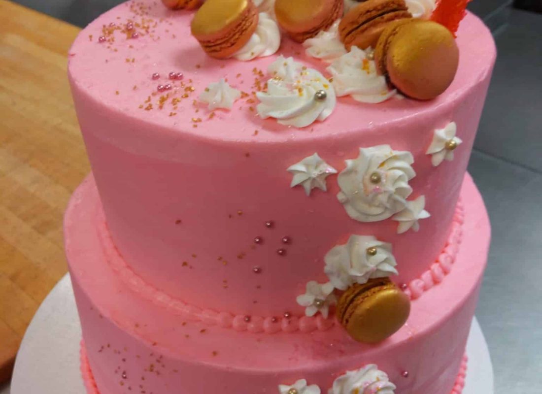 Decorator finishing a Customized Birthday Cake for a Friendswood, TX family birthday party