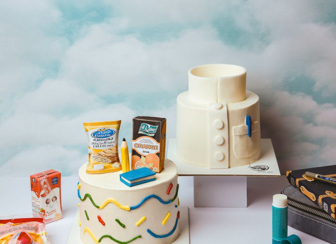 Decorator finishing a Customized Birthday Cake for a family party in Missouri City, TX bakery kitchen